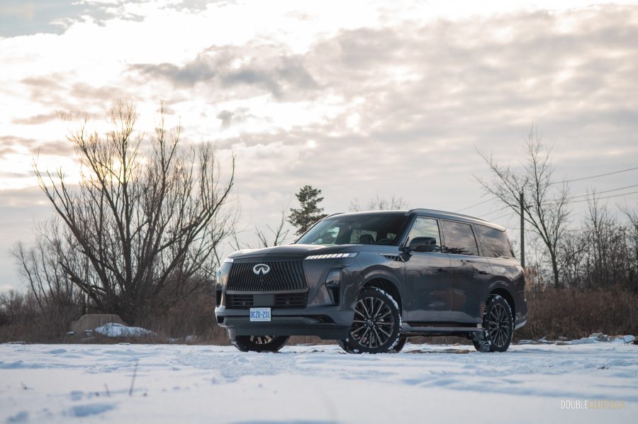 2025 Infiniti QX80 Autograph front three quarter on snow at sunset