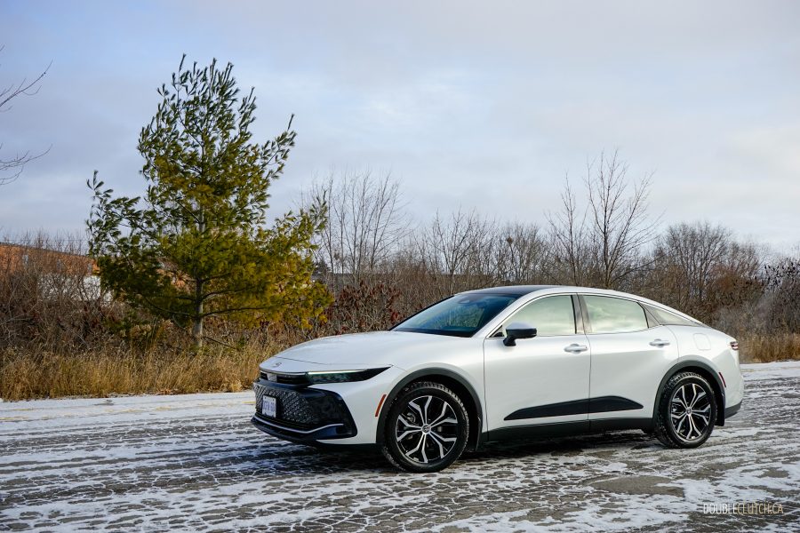 A white 2025 Toyota Crown against a backdrop of trees with snow on the ground
